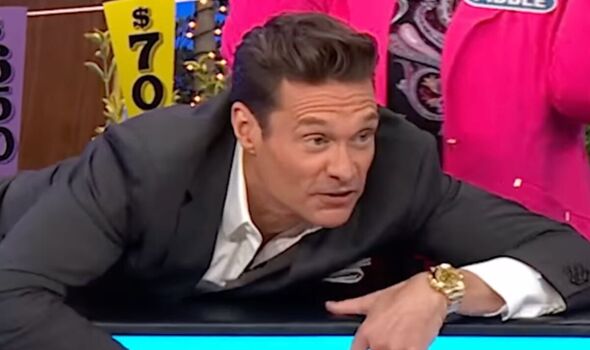 Ryan Seacrest slides in front of Wheel of Fortune player to save her
