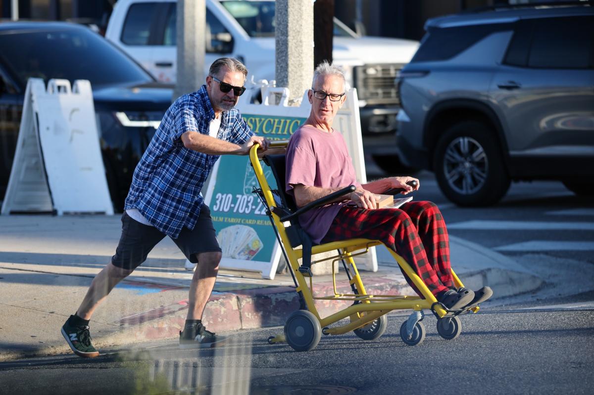 Frail Andy Dick spotted being pushed in wheelchair